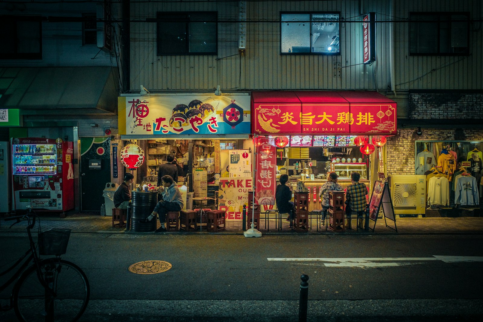 A small snack bar counter in Tokyo lined with bottles, the kind of intimate space where the mama-san serves regulars