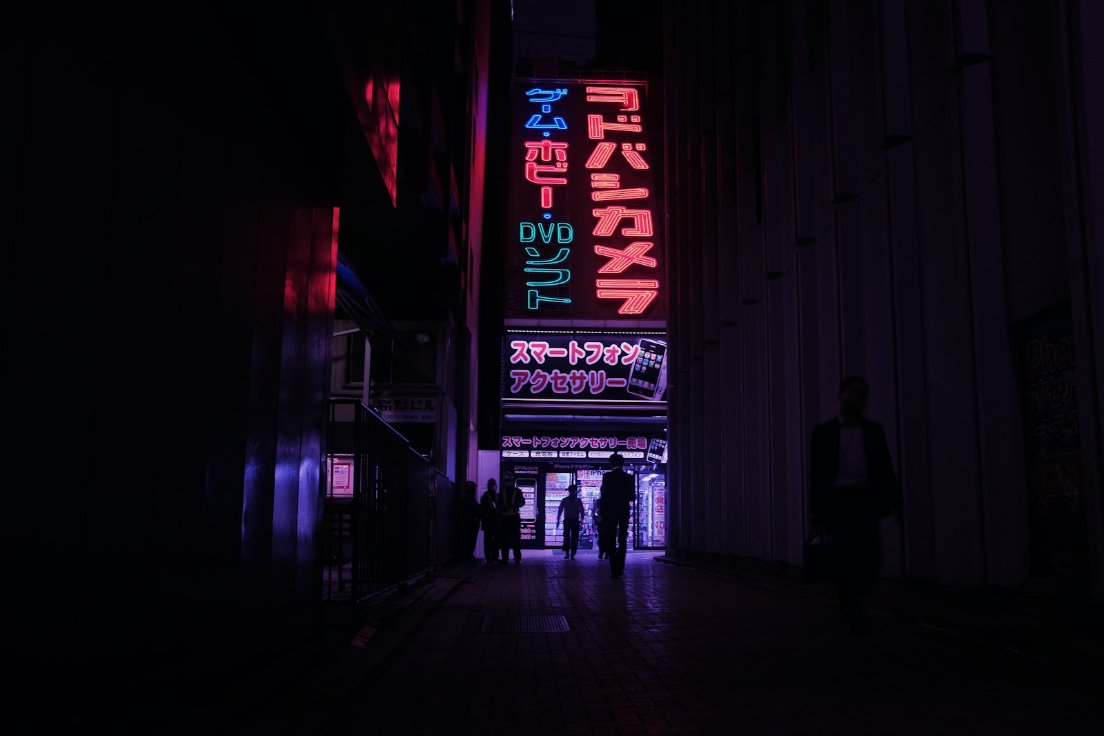Neon-lit Tokyo street at night, where a handful of themed cafes stay open into the evening