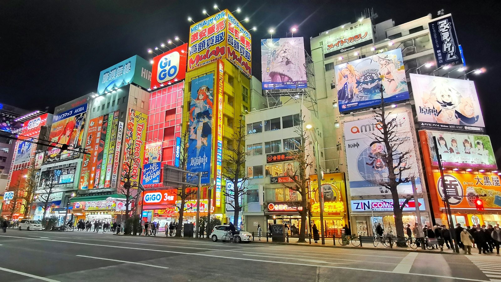 Akihabara's electric town glowing at night, home to Tokyo's maid cafes and anime themed cafes