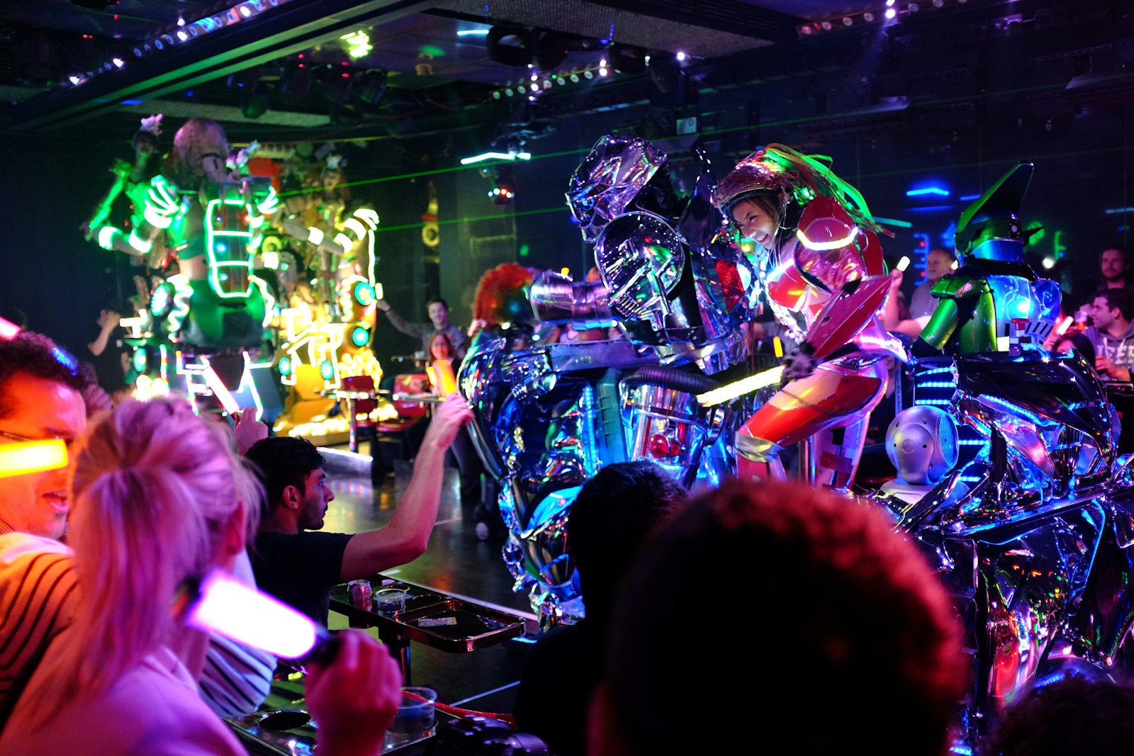 Crowd dancing under colored lights at a Tokyo nightclub