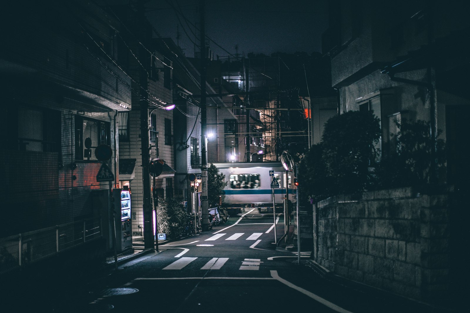 Late-night street in Tokyo with taxis waiting after a club night