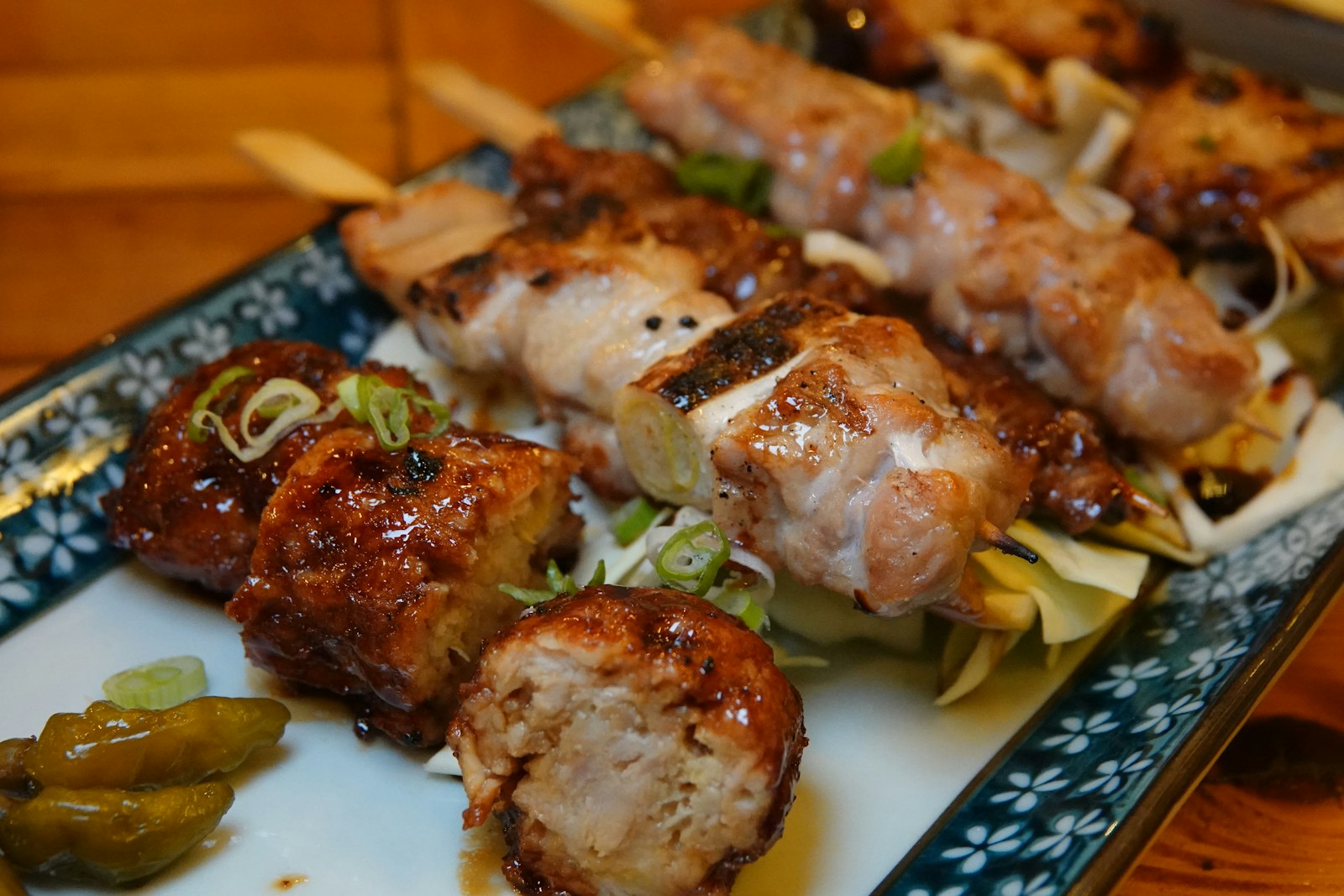 Yakitori skewers grilling over charcoal at a Tokyo izakaya
