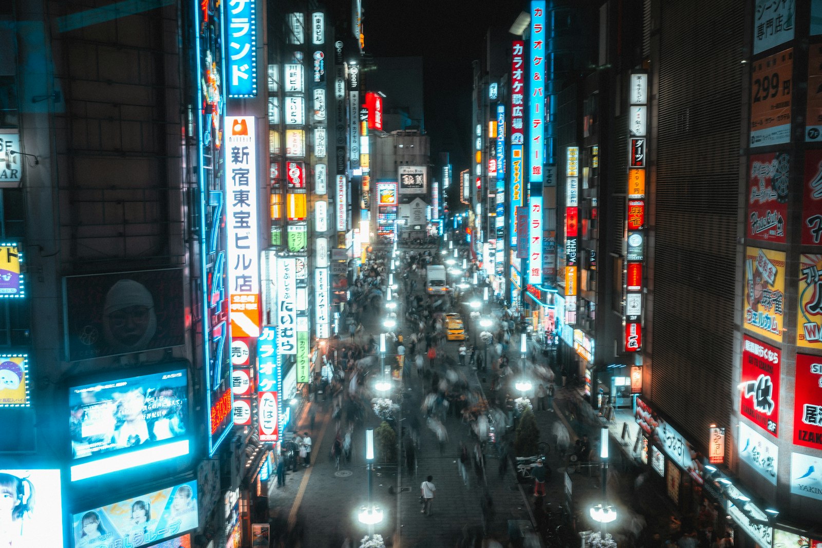 Neon-lit Kabukicho street in Shinjuku late at night after the last train