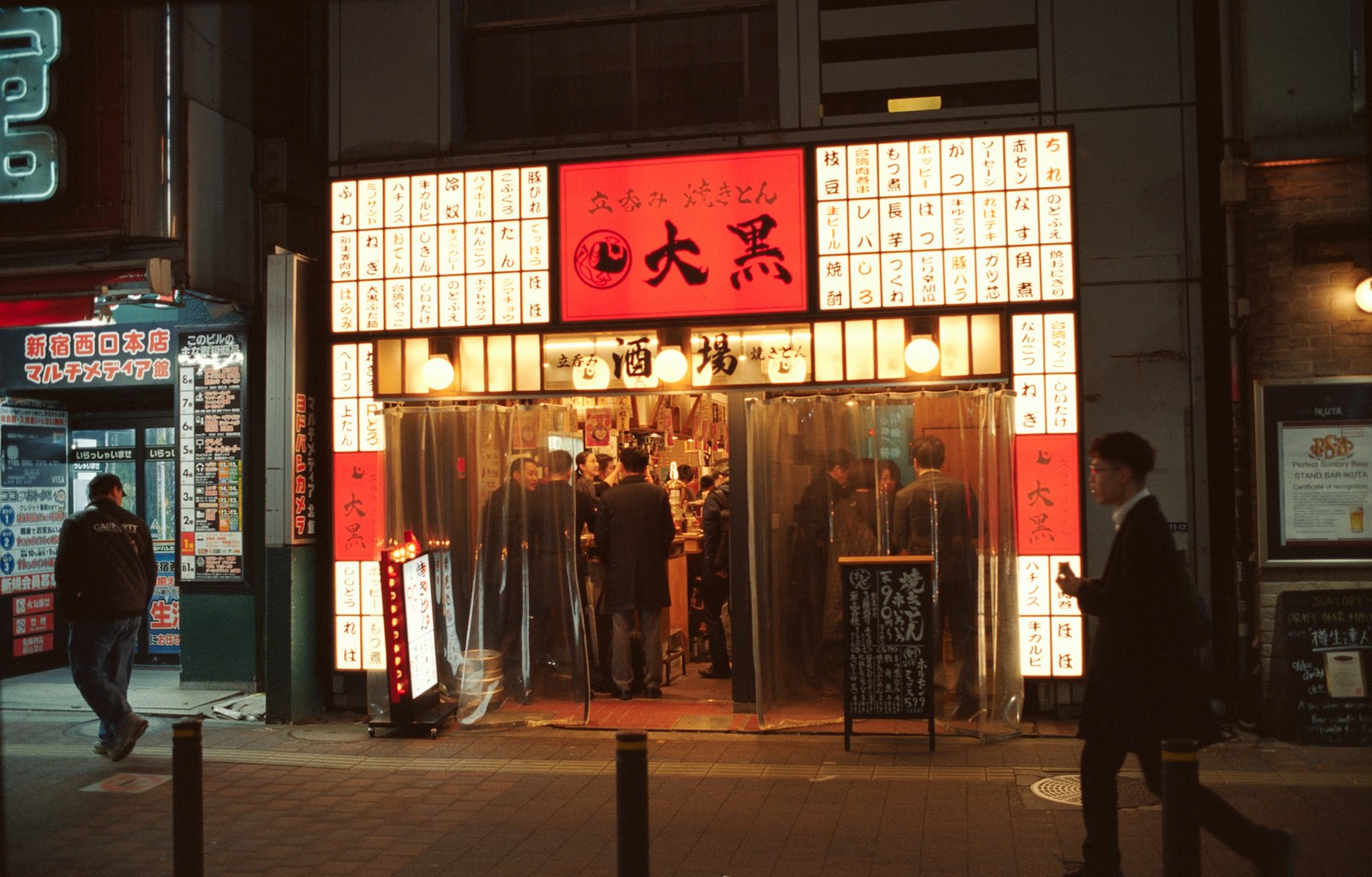 Neon-lit Shinjuku street at night where many Tokyo night food walks begin