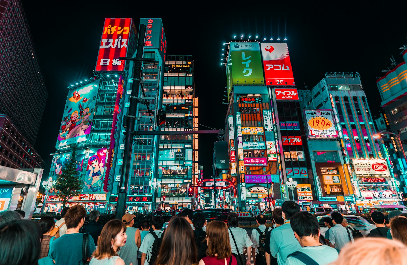 Group of friends walking under the neon signs of Shinjuku on a Tokyo night tour
