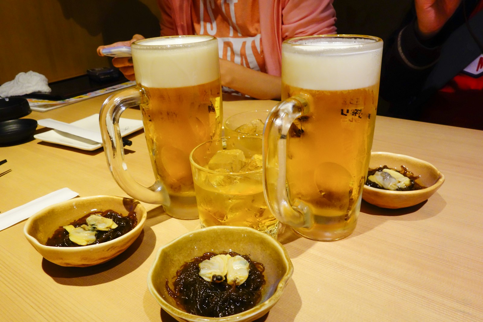 Group of friends raising a toast at an izakaya during a Tokyo nightlife evening