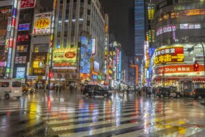 Neon signs lighting up a Shinjuku street at the start of a Tokyo night tour