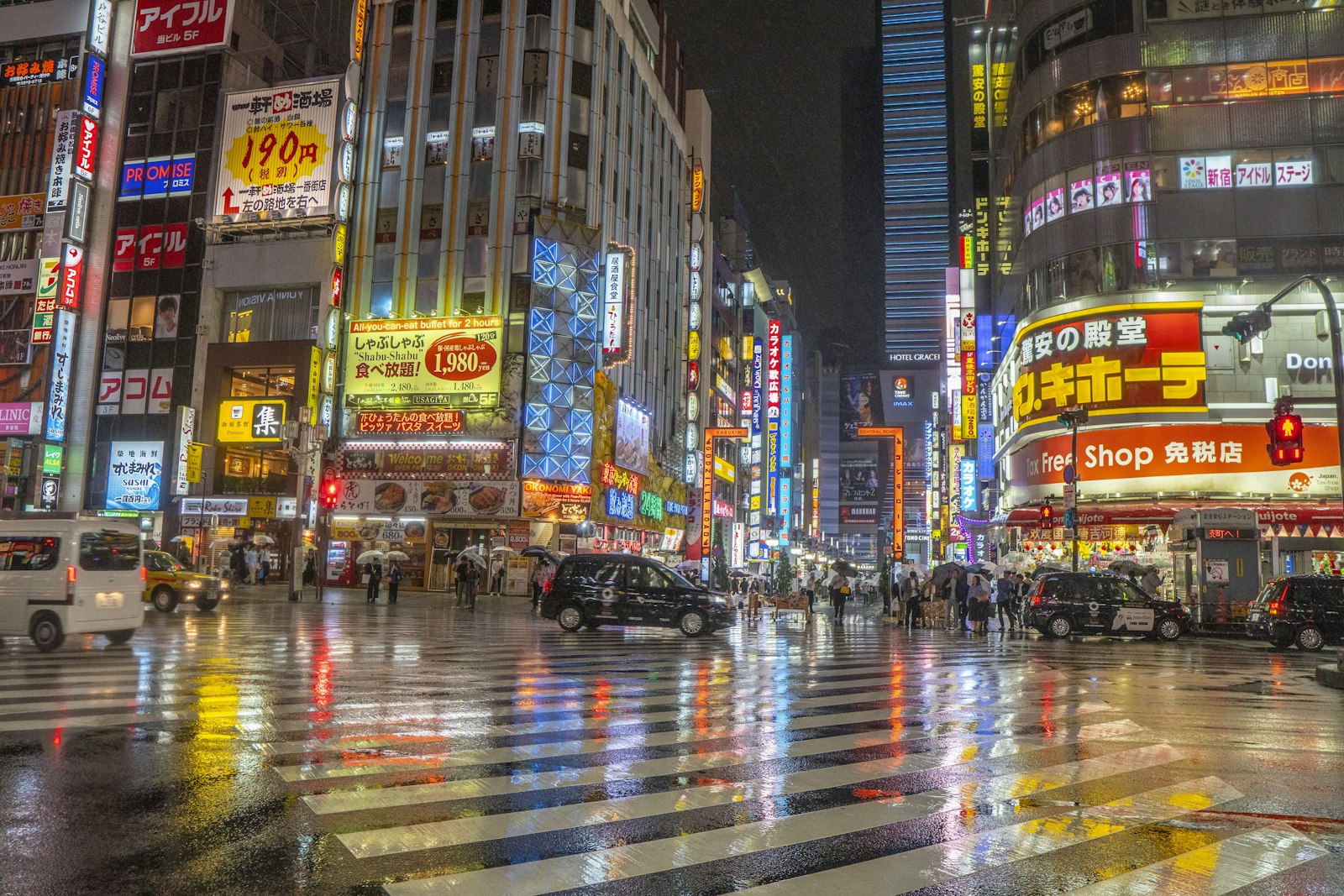 Neon signs lighting up a Shinjuku street at the start of a Tokyo night tour