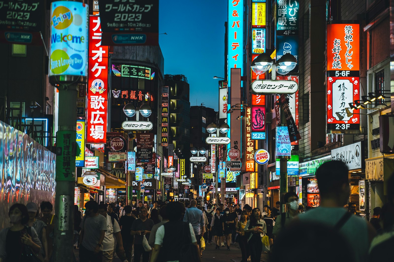 Narrow alley of small lantern-lit bars in Tokyo at night, typical of a guided night walking tour stop