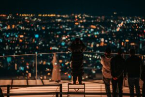 A couple looking out over the Tokyo skyline at night from an observation deck