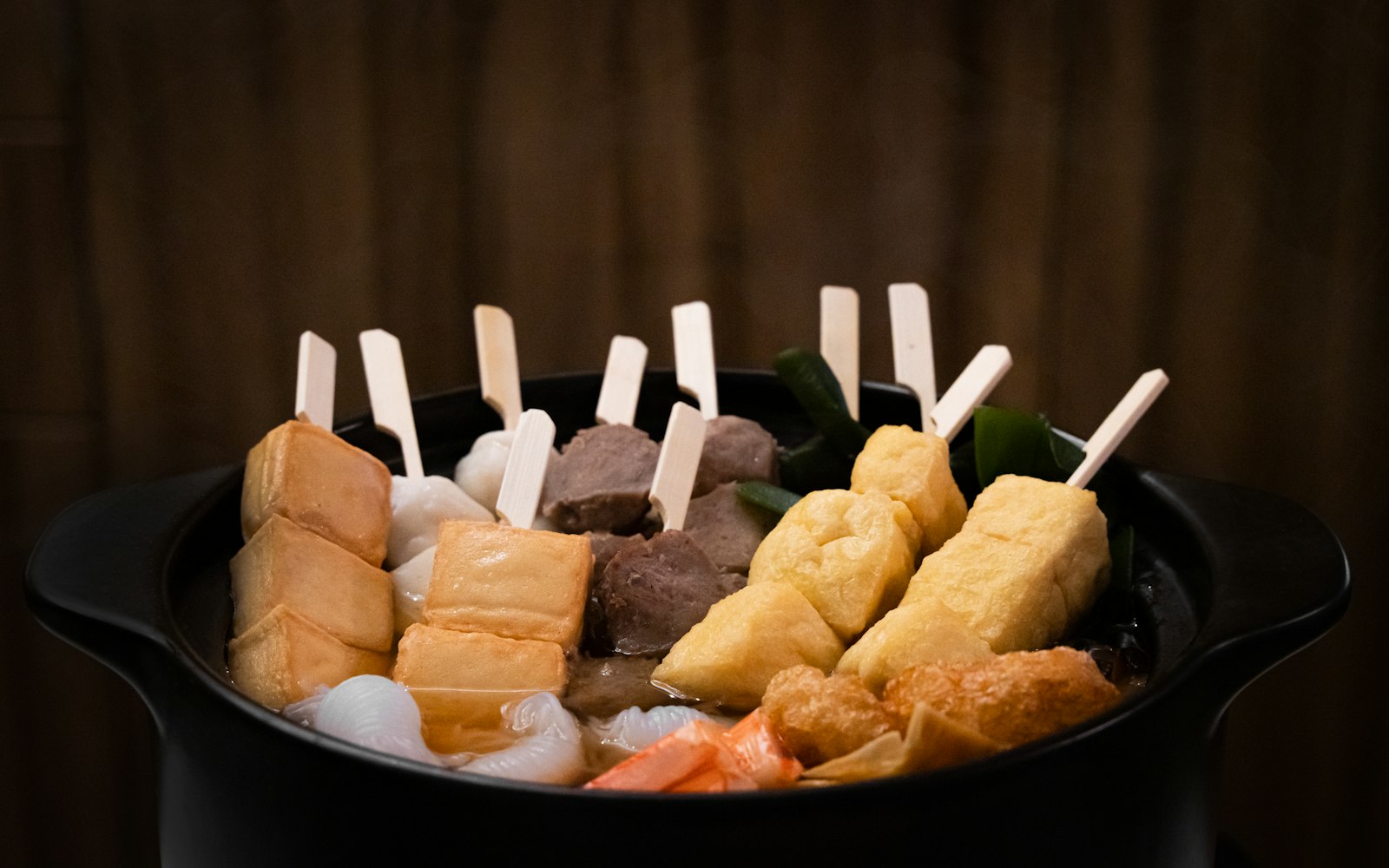A pot of oden simmering at an izakaya counter, a classic winter dish on Tokyo nights out