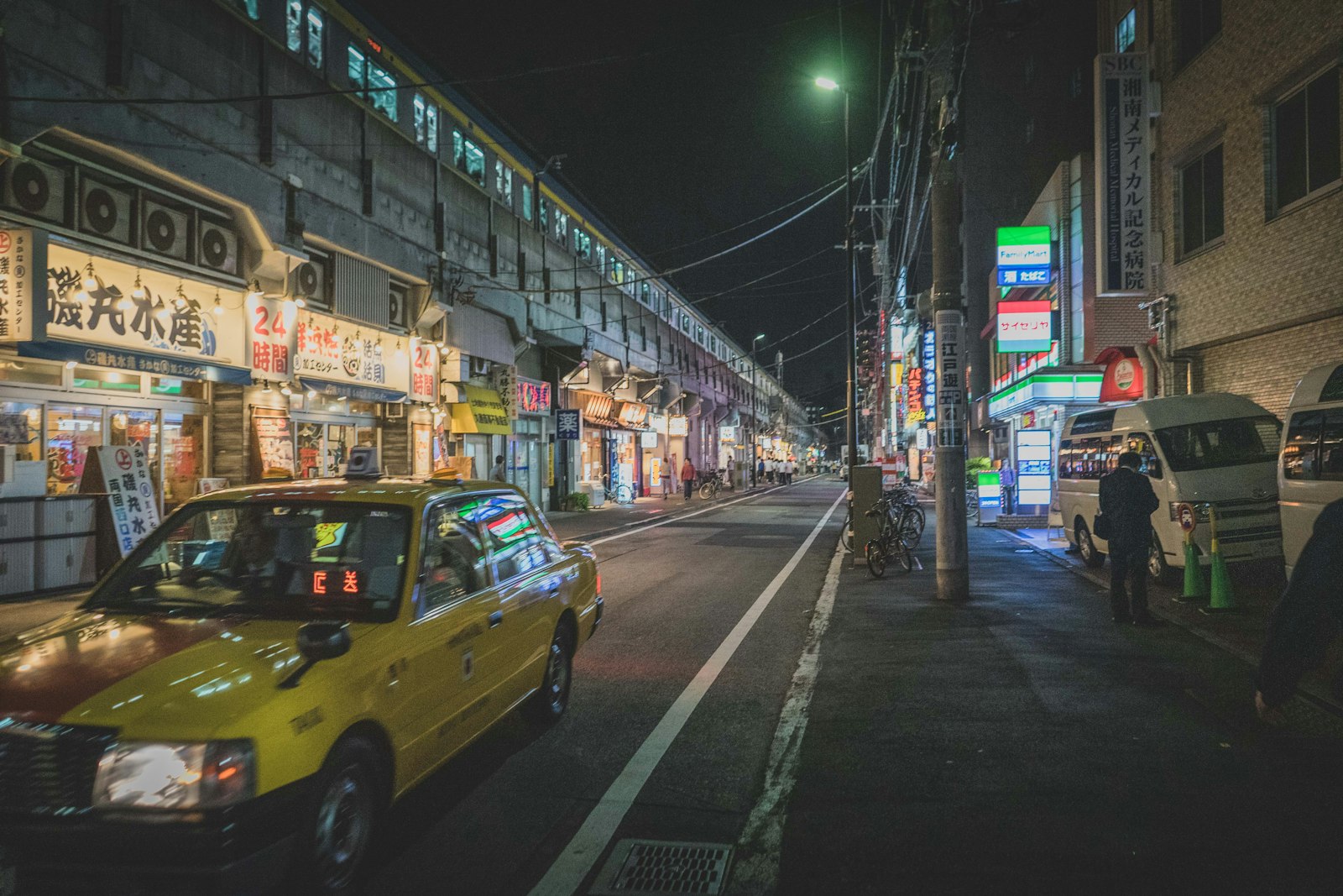 A Tokyo taxi waiting on a quiet street late at night