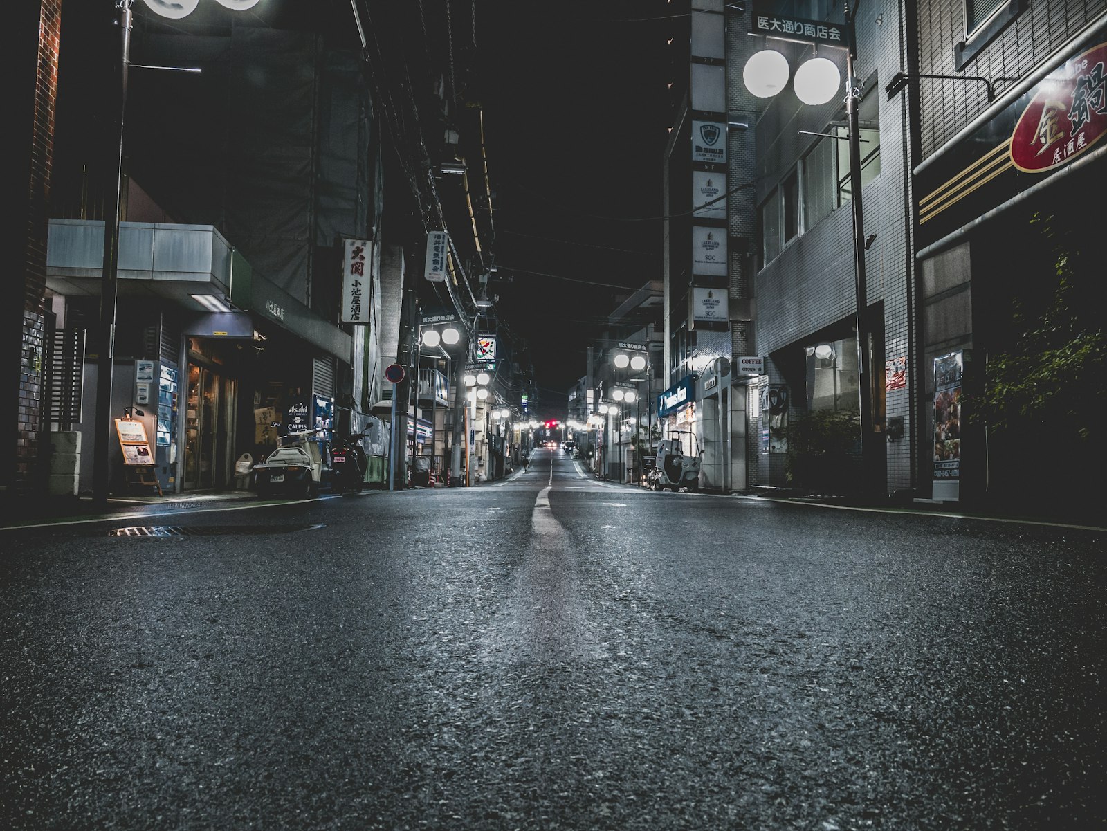 Narrow alley of tiny bars in Shinjuku Golden Gai, where most bars post a seat charge by the door