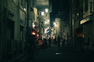 Red lanterns glowing outside izakaya in the Yurakucho gado shita under the tracks district at night