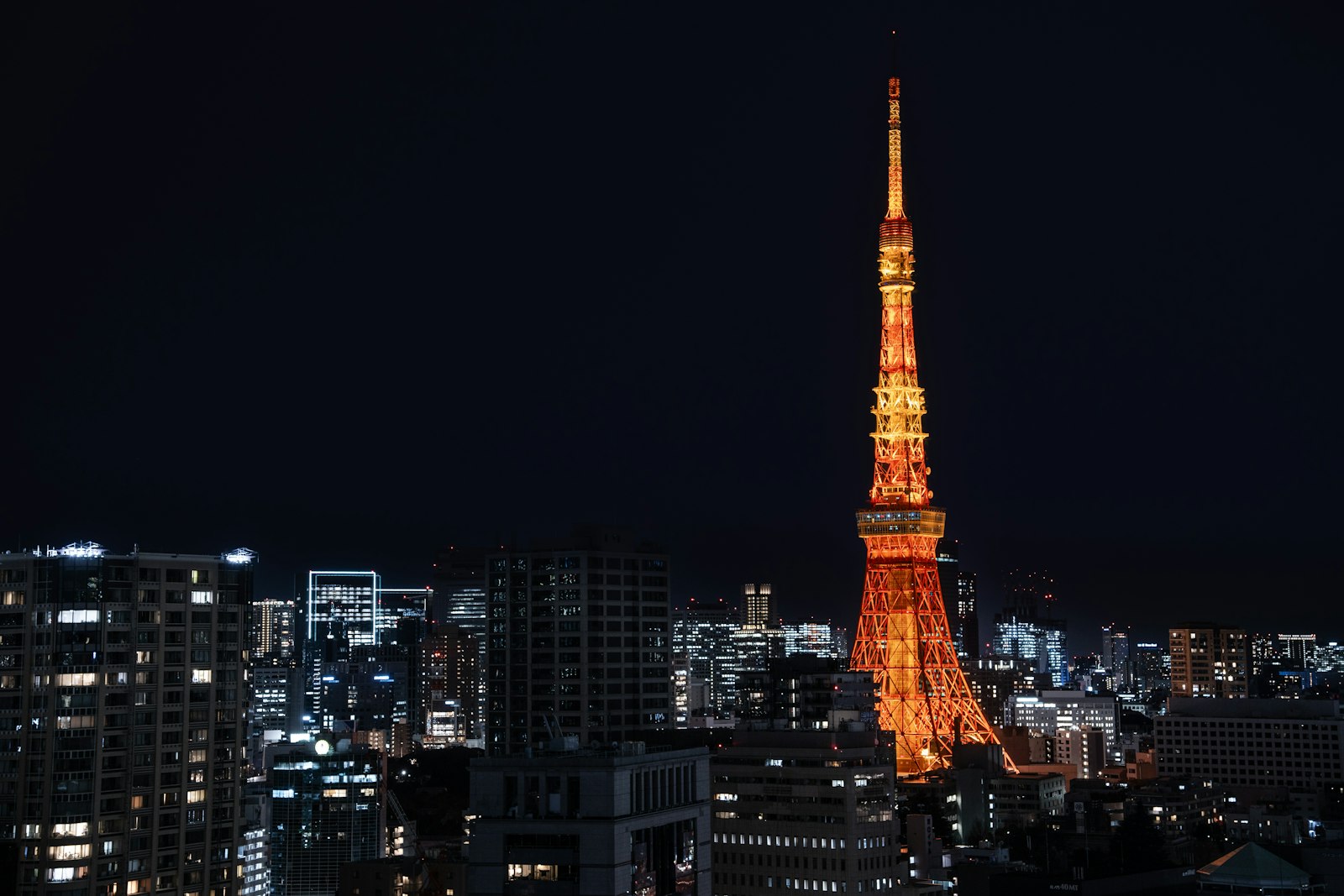 Tokyo Tower and the city skyline at night, similar to the free view from the Yebisu Garden Place sky lounge