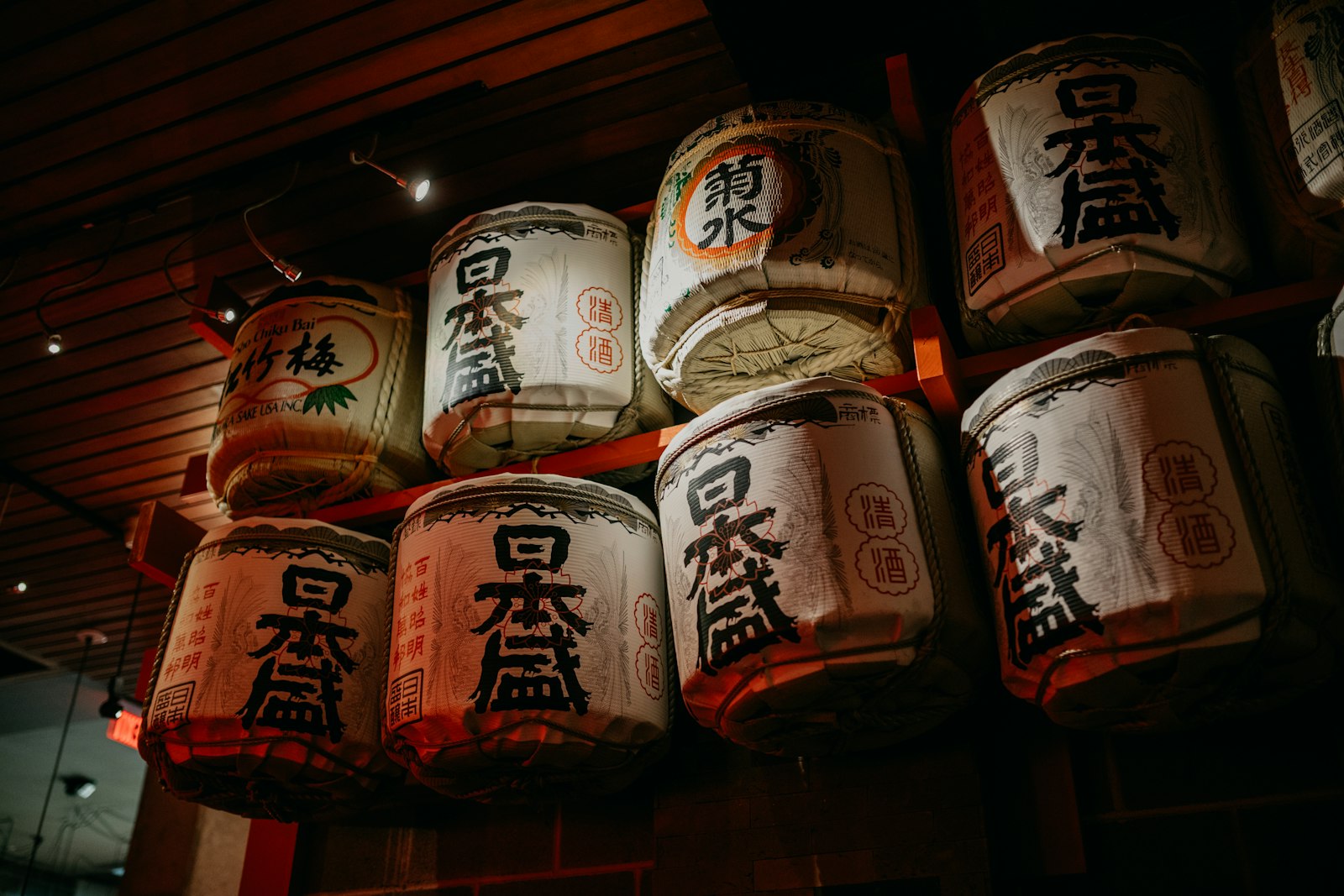 Rows of Japanese sake on a bar counter, like the one-cup sake wall at a standing bar in Ebisu