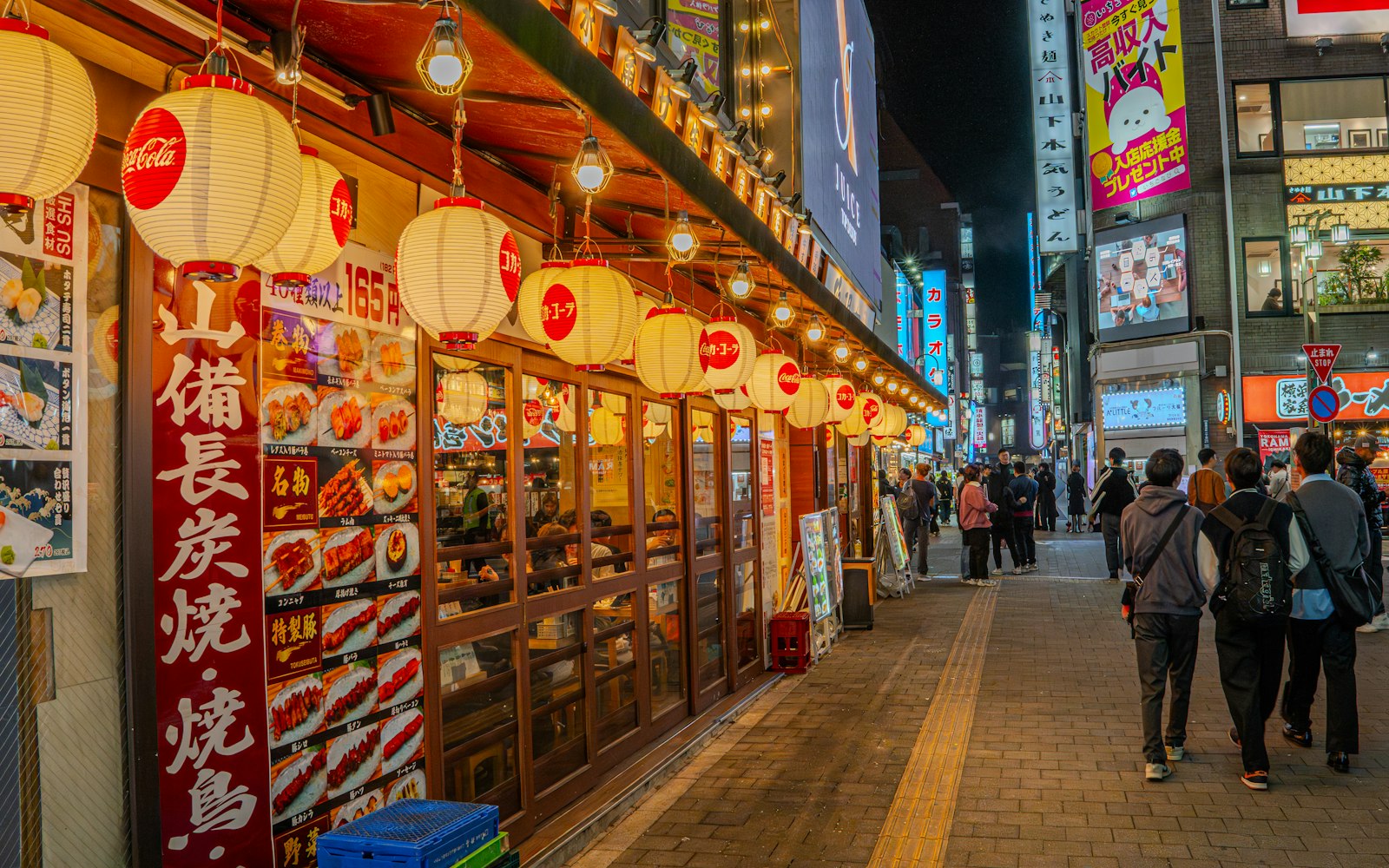 Family sharing dishes at a casual Tokyo restaurant in the evening
