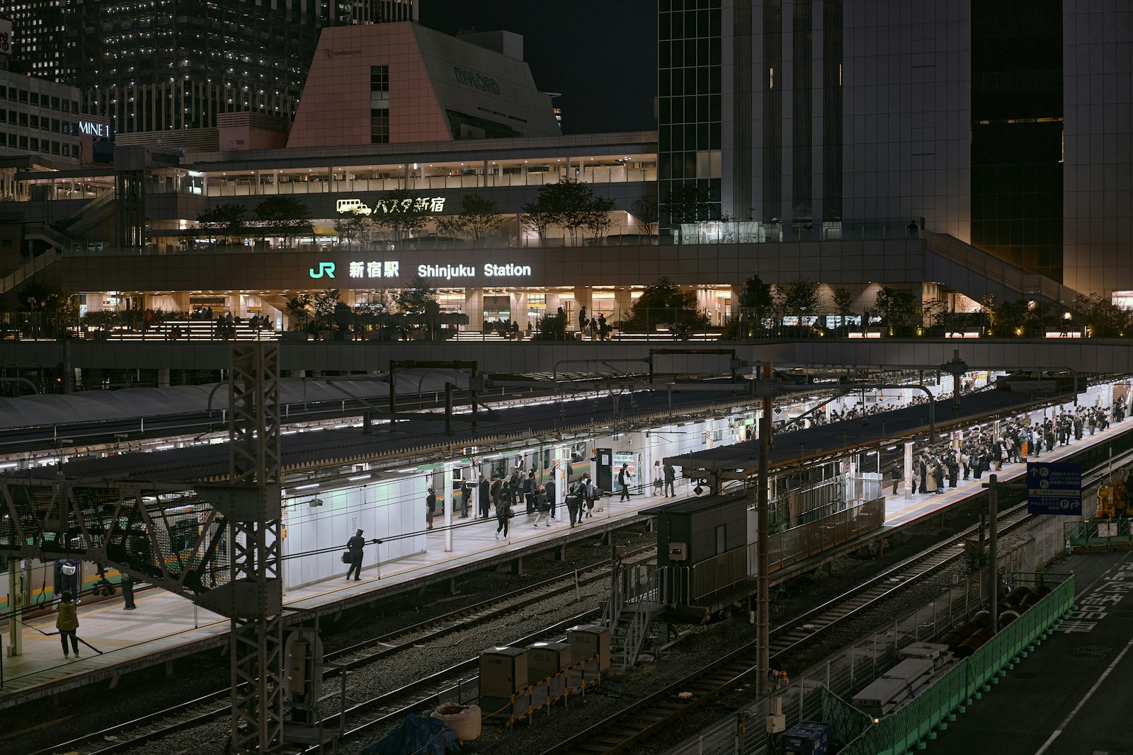An almost empty Tokyo train station platform late at night after the last train has left