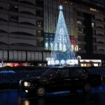 Neon signs and crowds on a street near Ikebukuro Station at night