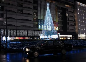Neon signs and crowds on a street near Ikebukuro Station at night