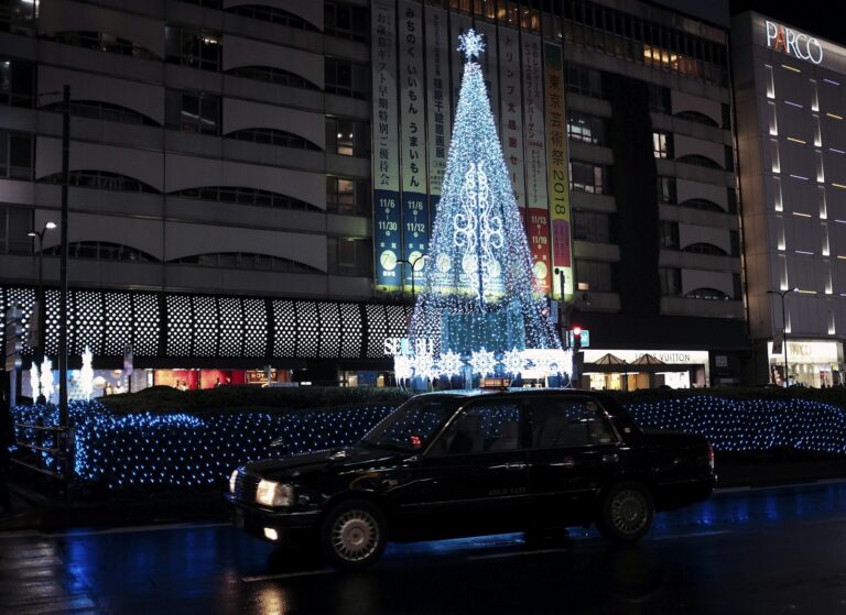 Neon signs and crowds on a street near Ikebukuro Station at night