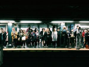 Office workers in suits gathering outside Shimbashi Station in Tokyo in the evening