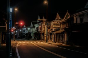 A narrow Shimokitazawa street at night lined with small shops and bars, the heart of Shimokitazawa nightlife