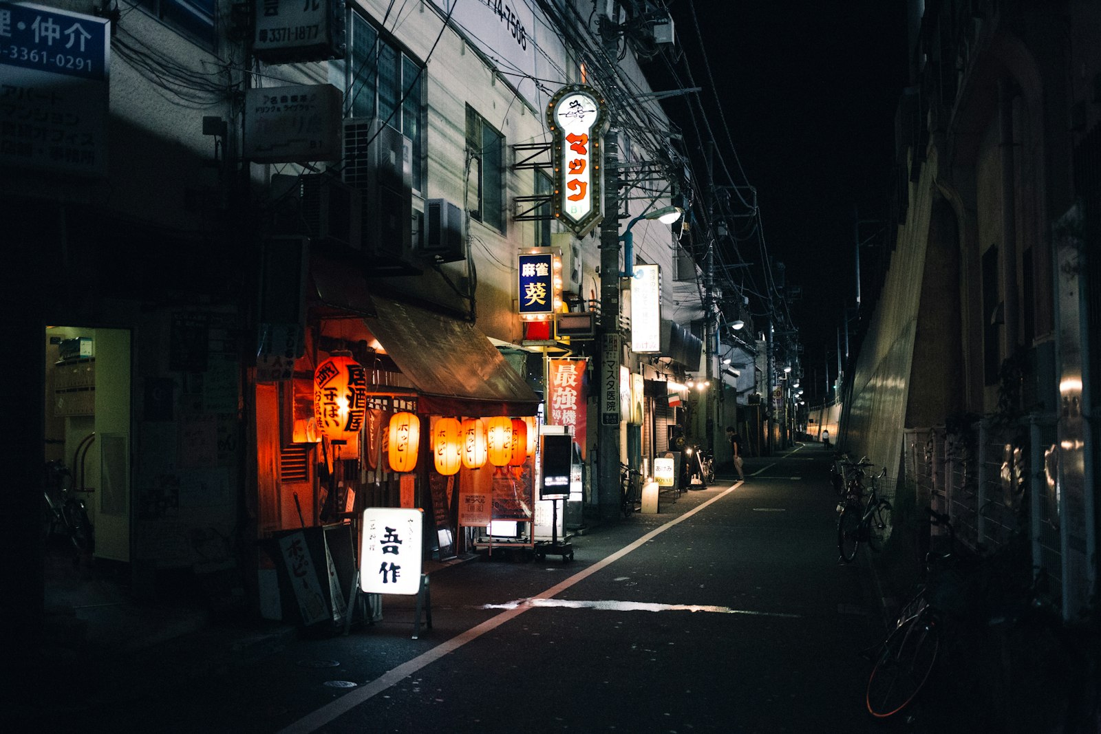 Red paper lanterns lighting the narrow Omoide Yokocho alley in Shinjuku at night