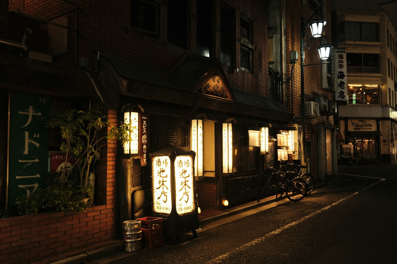 Drinks being served at a Tokyo izakaya counter at night