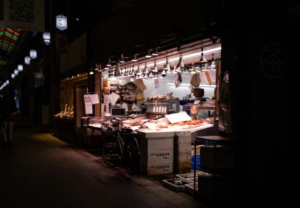 Bartender preparing a cocktail at a counter in a Tokyo bar, where tipping is not expected