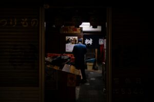 Busy Tokyo izakaya counter at night, the kind of spot popular with foreigners visiting Japan