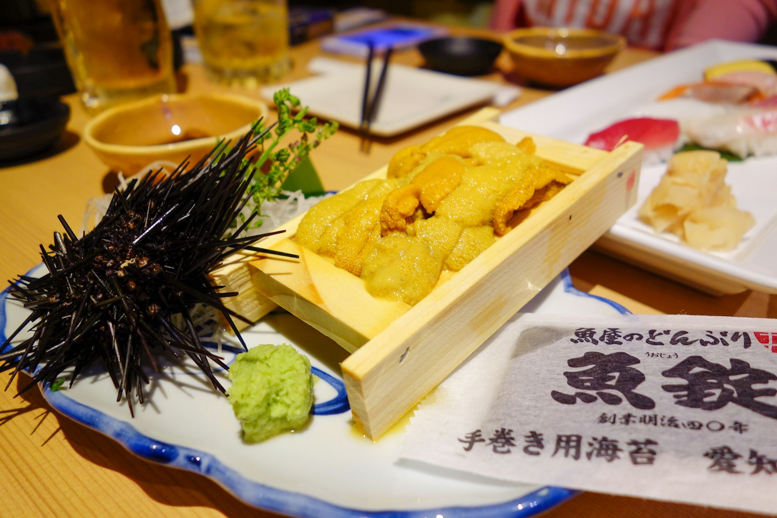 Fresh sashimi platter on a wooden table at a seafood izakaya in Tokyo