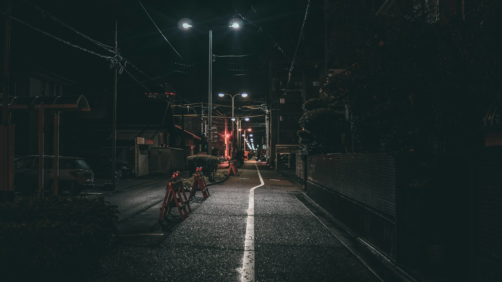 Red lanterns and diners under the brick railway arches in Yurakucho, Tokyo, at night