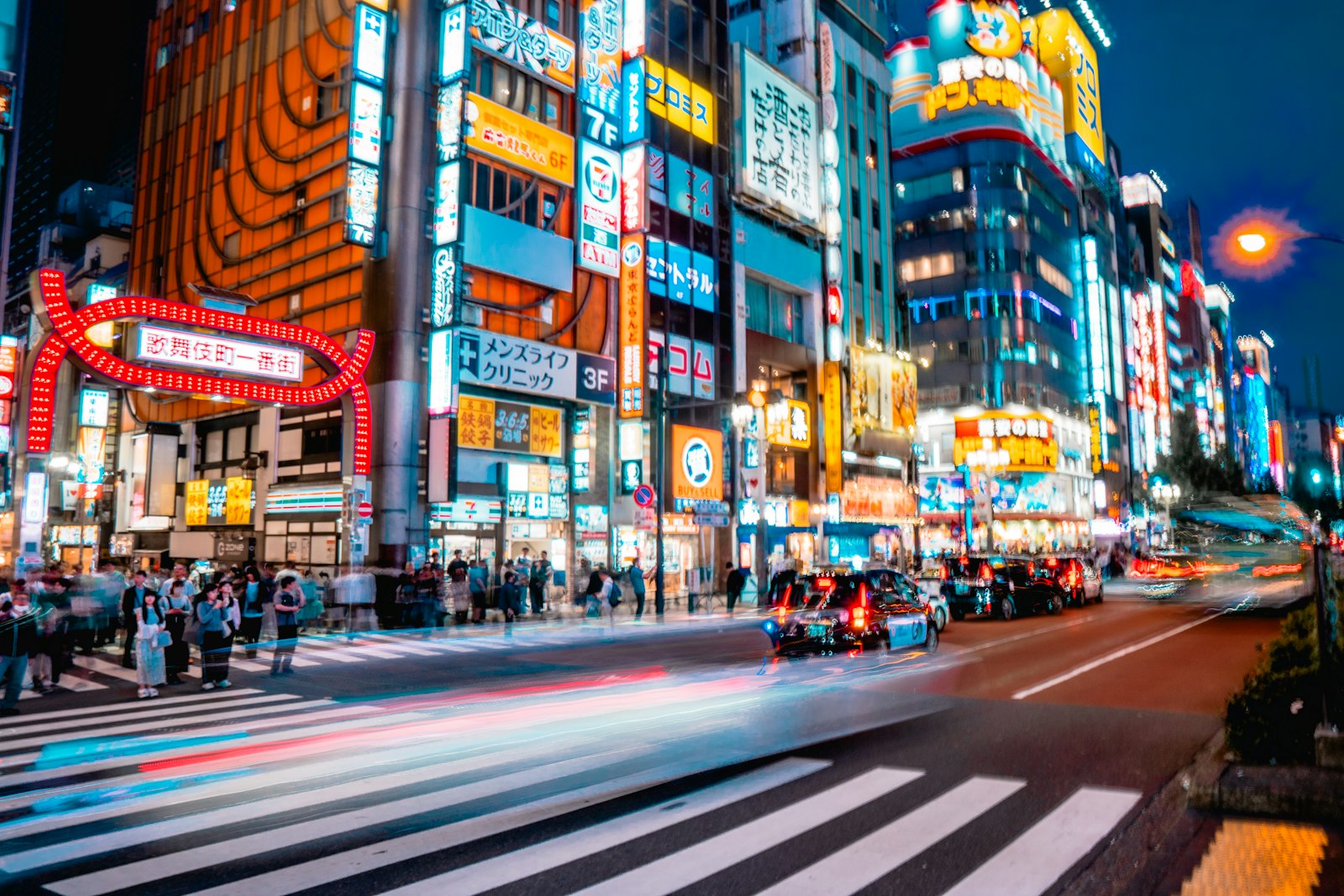 Taxis lined up on a neon-lit Shinjuku street late at night