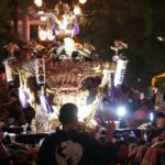 Rows of glowing paper lanterns at a Tokyo night festival matsuri at a Shinto shrine