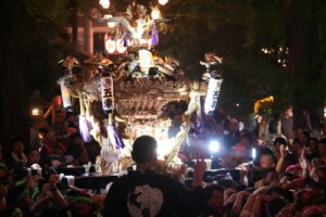 Rows of glowing paper lanterns at a Tokyo night festival matsuri at a Shinto shrine
