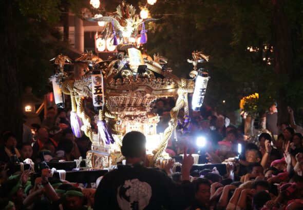 Rows of glowing paper lanterns at a Tokyo night festival matsuri at a Shinto shrine