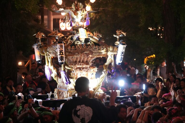 Rows of glowing paper lanterns at a Tokyo night festival matsuri at a Shinto shrine