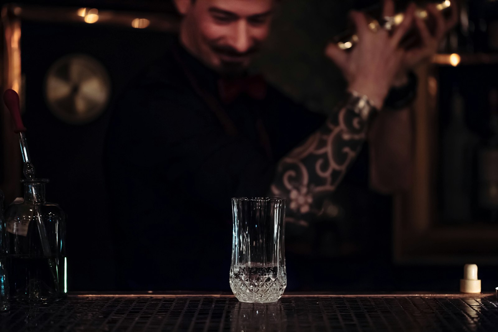 Bartender stirring a cocktail at a quiet counter, a highlight of Tokyo nightlife over 30