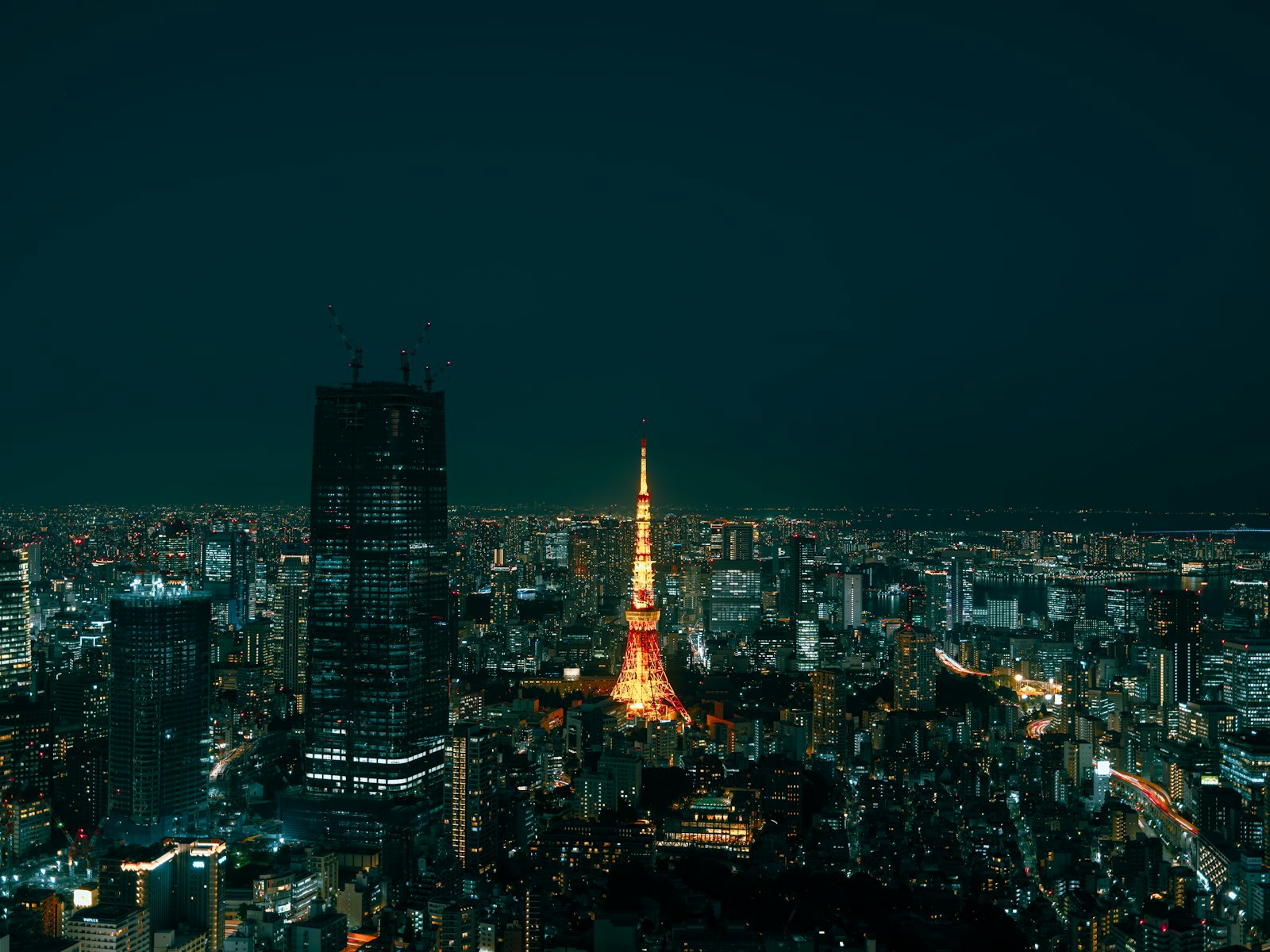 Tokyo Skytree lit up at night above the rooftops of Sumida
