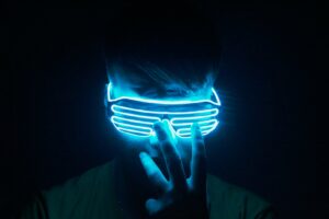 A traveler wearing a VR headset under neon light, enjoying a Tokyo VR experience at night