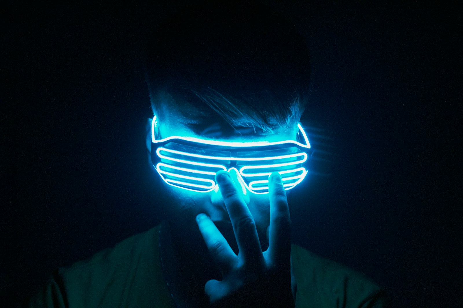 A traveler wearing a VR headset under neon light, enjoying a Tokyo VR experience at night