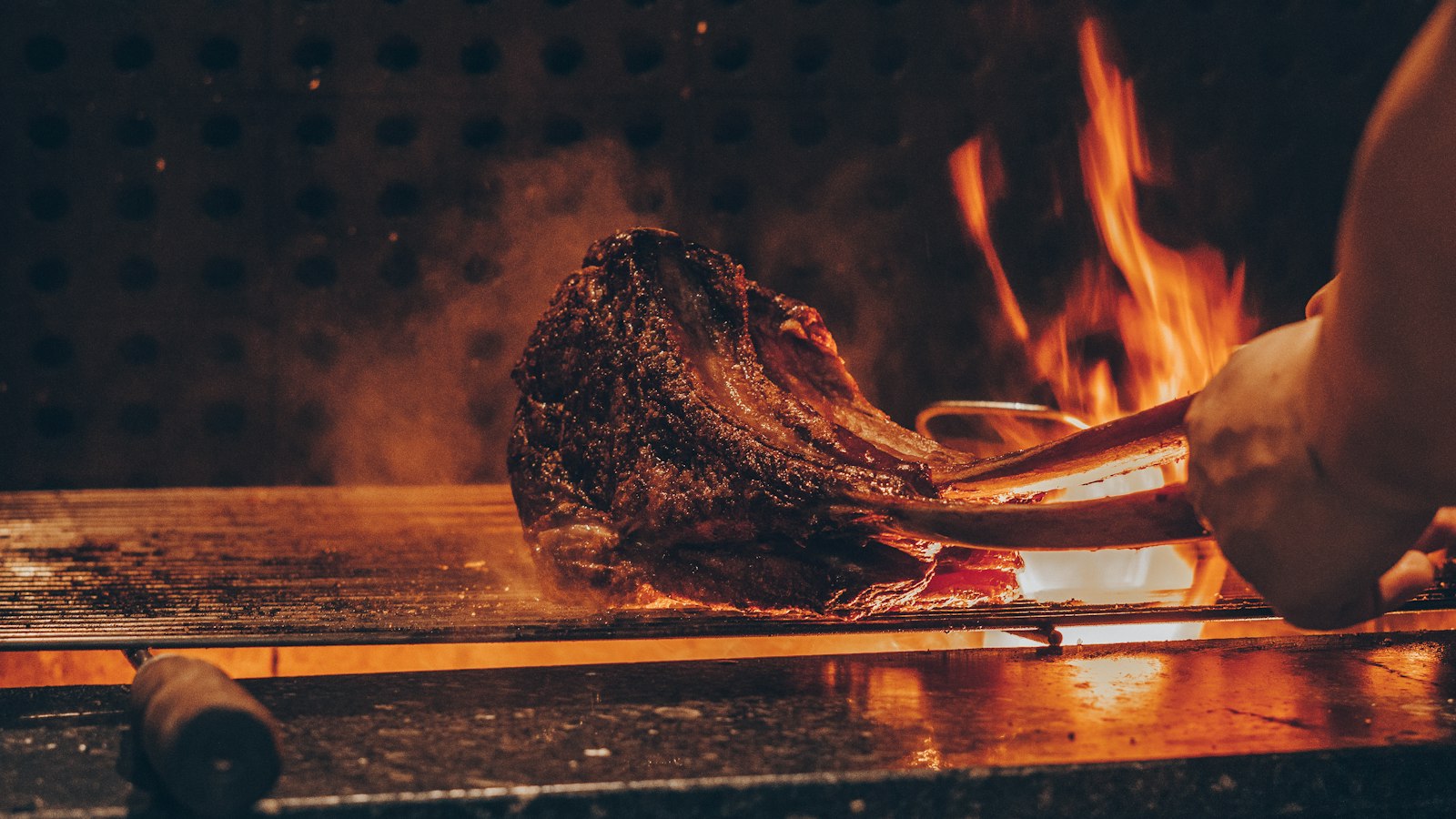 Chef searing wagyu steak on a teppanyaki iron griddle at a Tokyo restaurant