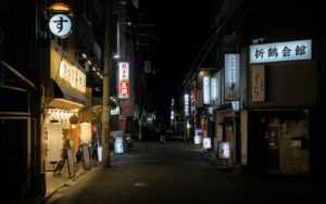 Ueno bar hopping crowd at outdoor izakaya tables along Ameyoko at night