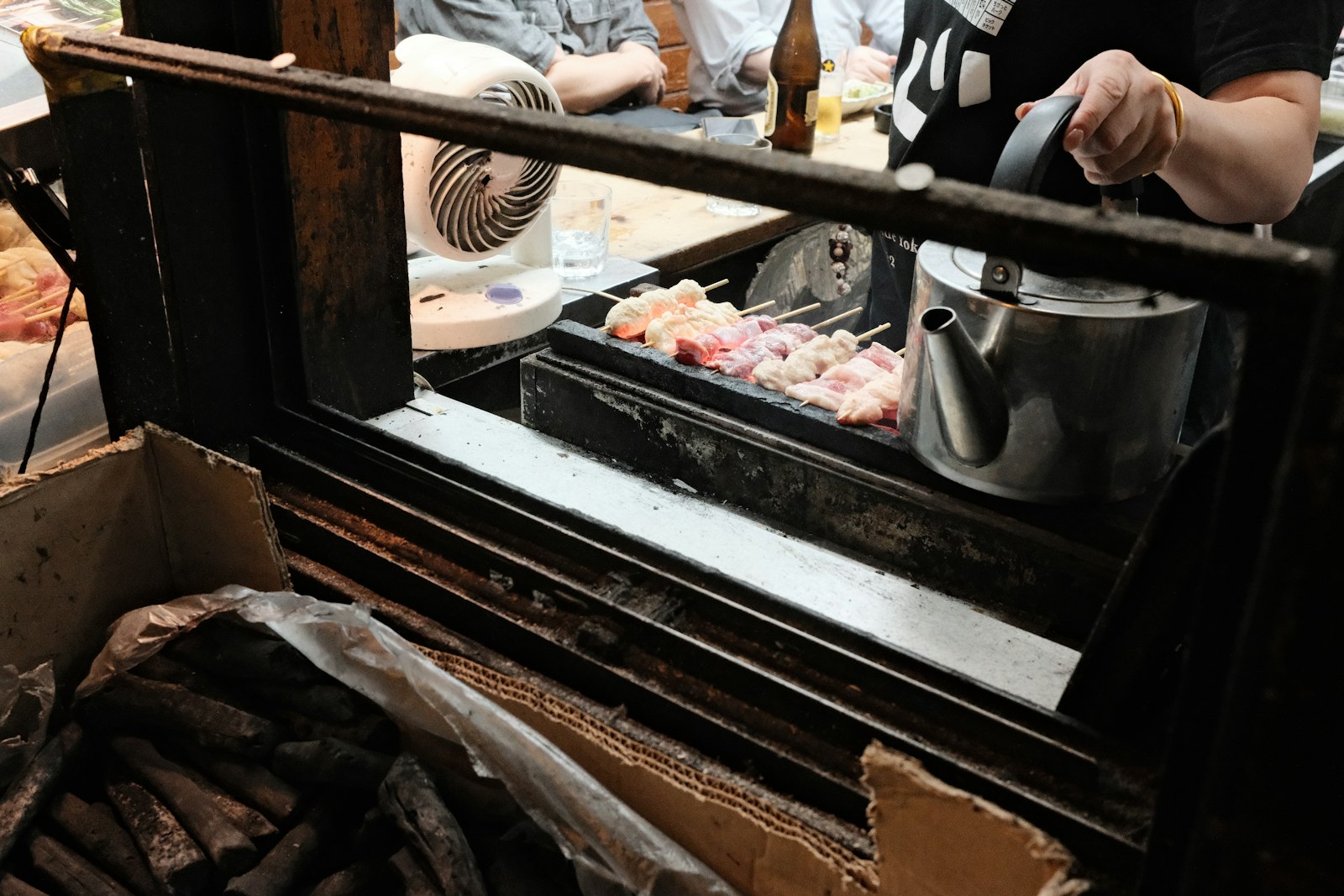 Grilled offal skewers and beer at a standing bar during Ueno bar hopping