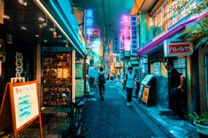 Neon-lit alley at night, the kind of side street where unique themed bars in Tokyo hide