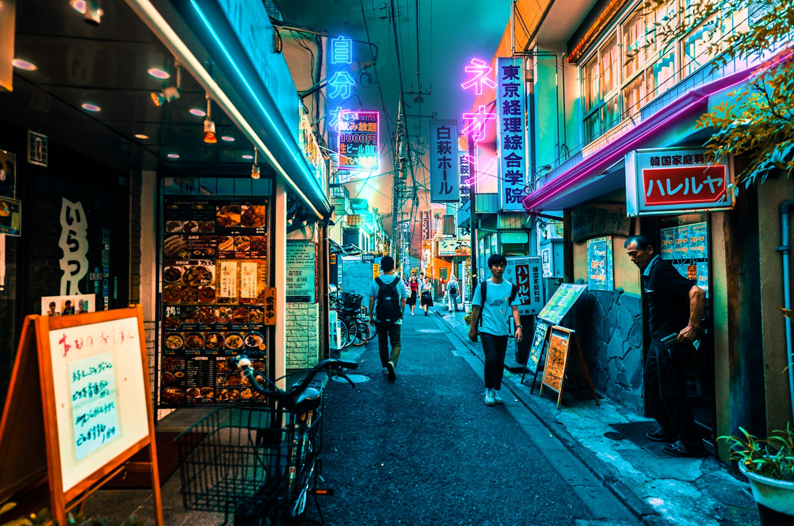 Neon-lit alley at night, the kind of side street where unique themed bars in Tokyo hide